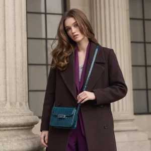 Black McLANEE Empress Crossbody Bag paired with an elegant evening dress
